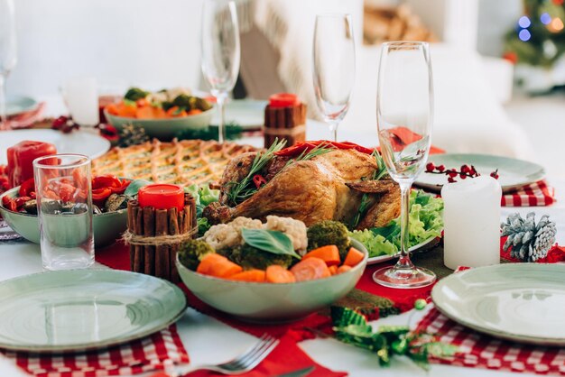 Selective focus of roasted turkey pie and cooked vegetables on table served for thanksgiving