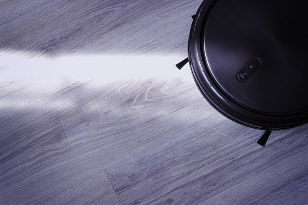 Selective focus of robotic vacuum cleaner washing parcet at night.