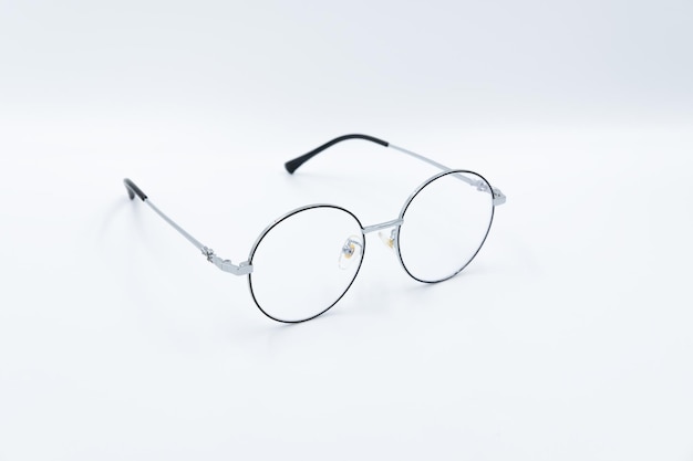 Selective focus round eyeglasses with silver rim Front right view Isolated white background