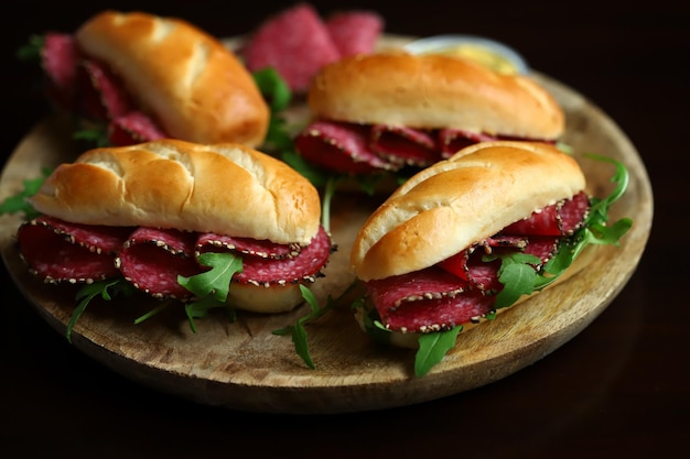 Selective focus Salami sandwiches with herbs and mustard