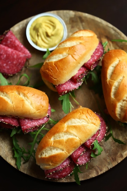 Selective focus Salami sandwiches with herbs and mustard