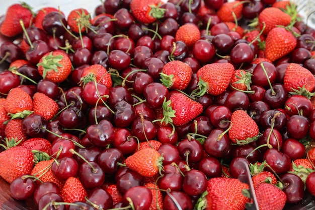 Selective focus shot of fresh strawberries and cherries