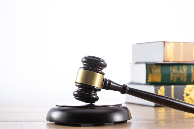 Selective focus shot of a gavel with a stack of books in the background law concept