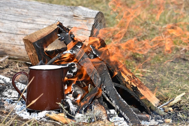 Selective focus shot of a mug on the fire