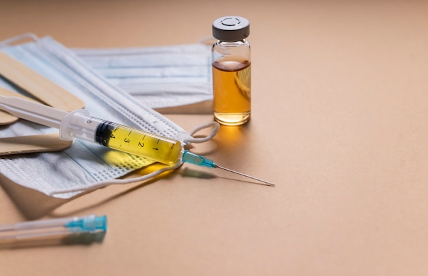 Selective focus. a single-use syringe with a vaccine, a serum from the virus. antiviral drug for covid-19 and seasonal diseases. flatlay