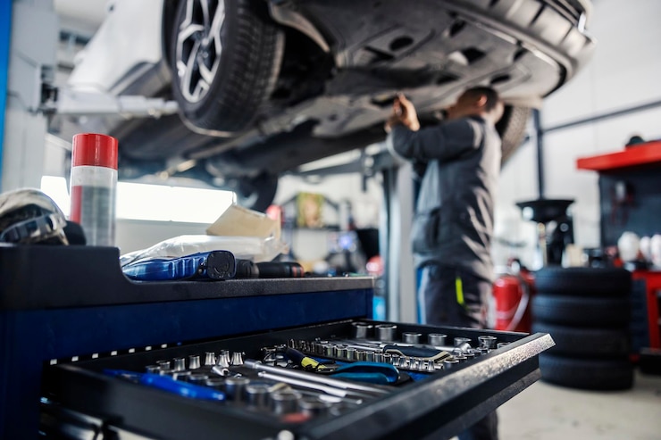 Photo selective focus on a tools in toolbox at mechanic39s shop with mechanic repairing the car