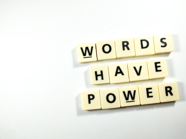 Selective focusScrabble letters with text WORDS HAVE POWER on white background