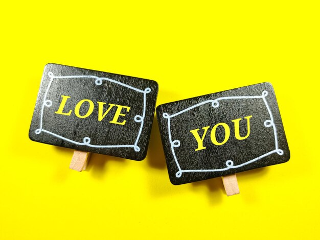 selective focuswooden board with word love you on yellow background