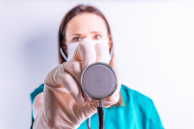 Selective view of surgeon's hand holding a stethoscope. concept Internal Medicine emergency medicine