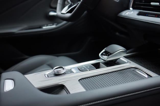 Selector automatic transmission with leather in the interior of a modern expensive car The background is blurred Black and brown leather car