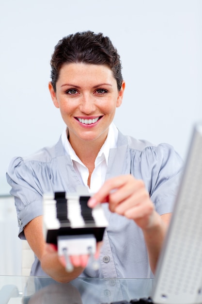 Self-assured business woman on phone searching for the index