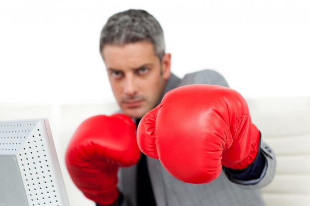 Self-assured businessman with boxing gloves 