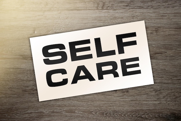 Photo self care text on card on wooden background healthcare concept stay home stay safe concept