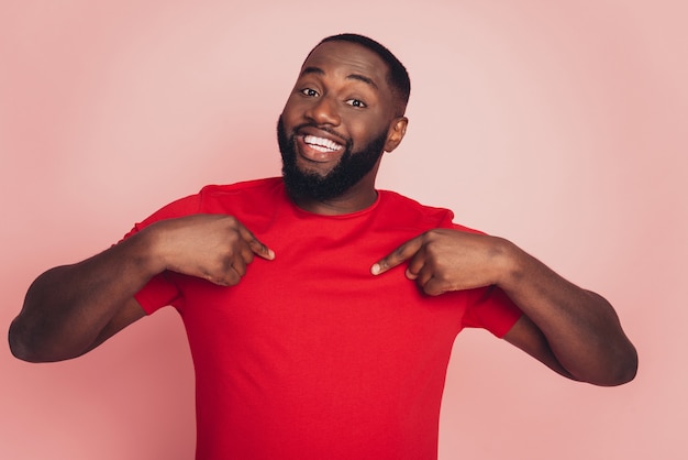 Self-confident dark skin man point finger himself isolated over pink background