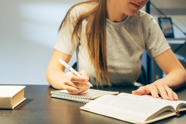 Self education distant learning student writing out notes