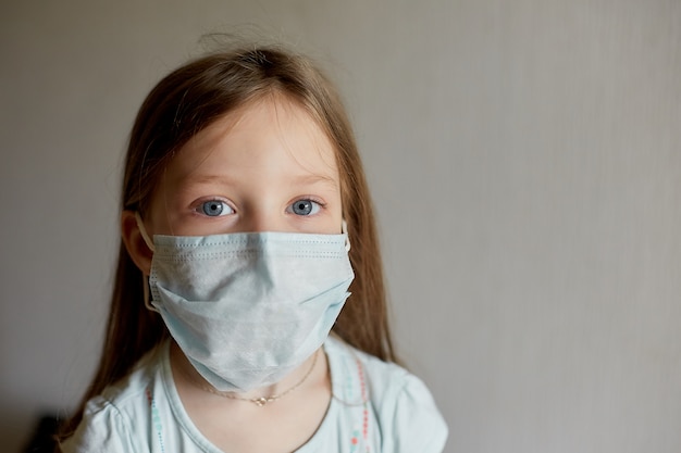 Self-isolation and quarantine, portrait of a girl in a medical mask