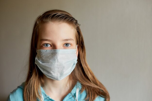 Self-isolation and quarantine, portrait of a teenage girl in a medical mask