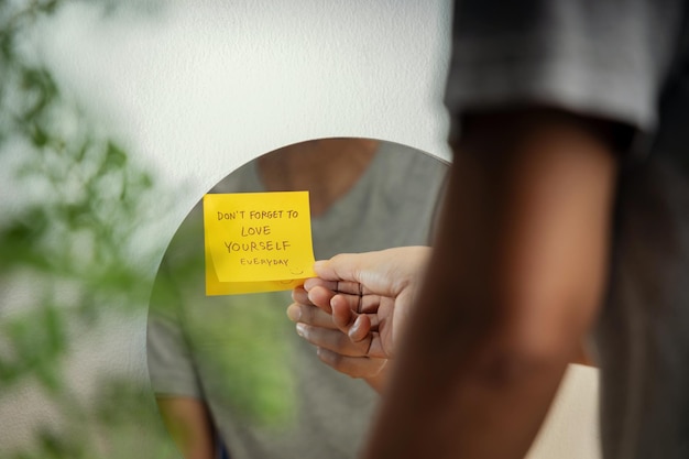 Photo self love concept person reading note on the mirror mental health remind and practice to start the day with a optimistic mind