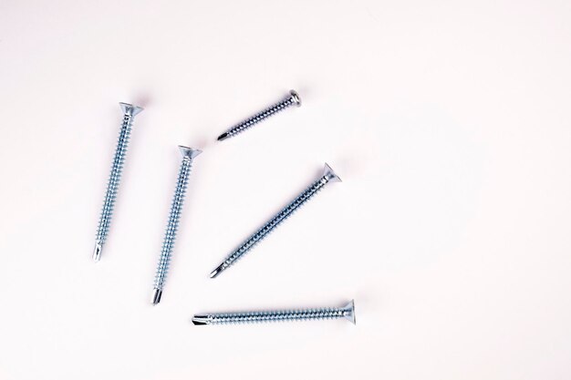 Photo self-tapping screws on a white background close-up. self-tapping screw flugel on a white background