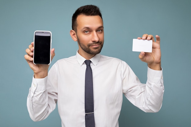 Selfconfident handsome good looking brunet businessman with beard wearing casual white shirt and tie