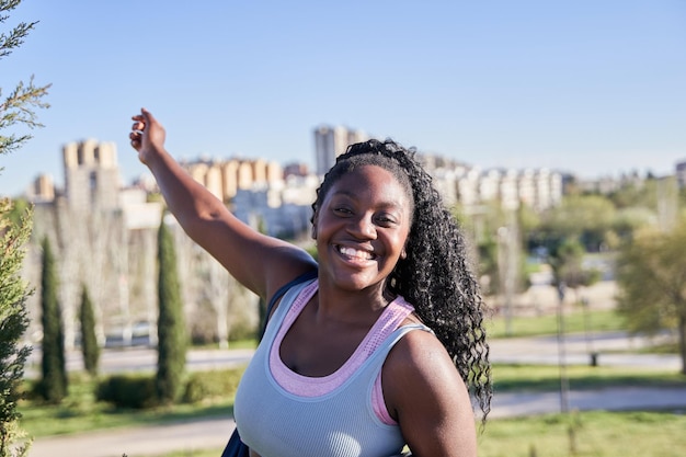 Photo selfie of an african american woman after training with the city in the background