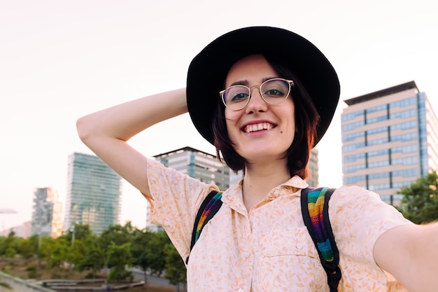 Selfie of a beautiful woman with glasses and hat