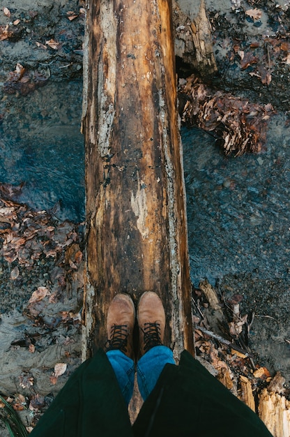 Photo selfie of feet in boots in autumn or spring forest travel and adventure