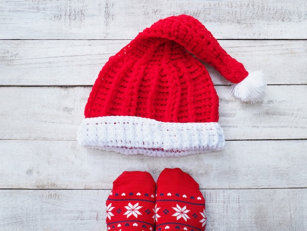 Selfie feet wearing red sock and Santa claus hat on vintage wood 