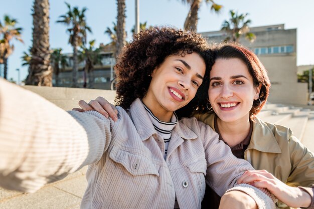 Selfie of a multiracial couple of girls smiling