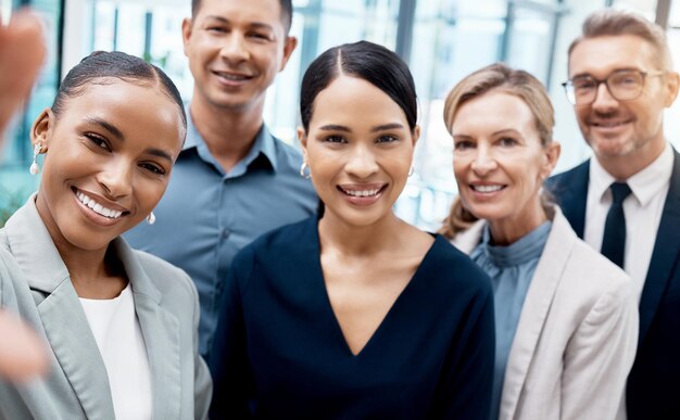 Selfie office and diversity business people or team standing in corporate workplace together Portrait trust and friends colleagues or group take picture for happy memory after boardroom meeting