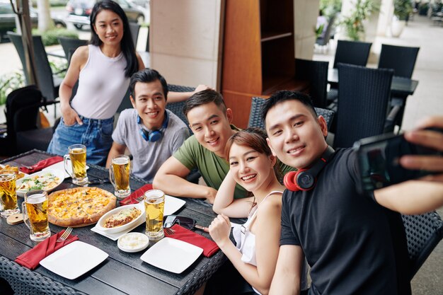 Selfie portrait of friends at restaurant