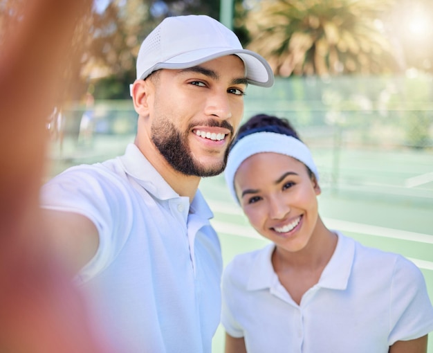 Selfie tennis and sports with a couple on a court to take a photograph after their training or game Portrait fitness and sport with a man and woman tennis player posing for a picture together