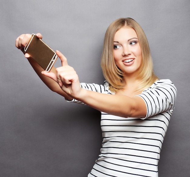 Selfie time. joyful young women making selfie by her smartphone