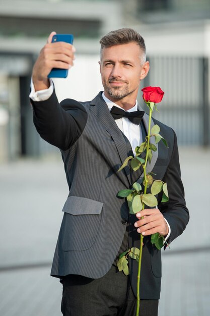 Selfie time man in tuxedo making selfie man in bowtie outdoor grizzled man taking selfie