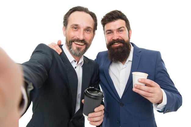 Selfie with friend. Lunch time. Small talk. Enjoying coffee. Bearded men communicate relaxing coffee break business conference. Visiting business convention or summit. Business people coffee break.