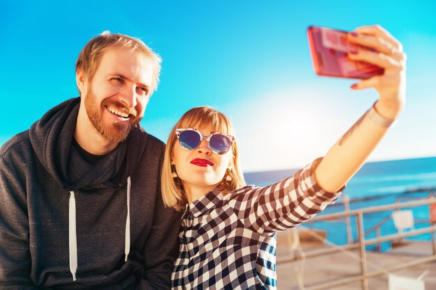 Selfie with happy friends. Brother and sister lifestyle at sea. Beautiful sunny day. Blue sky summertime. Summer