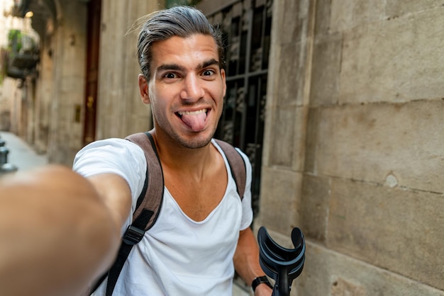 Photo selfie of young latin man with crutches in the street