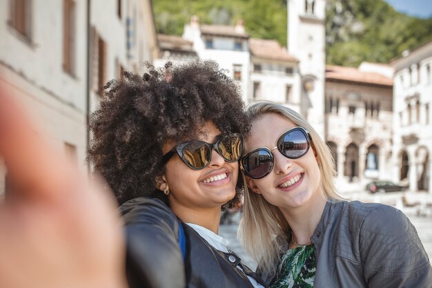 Selfies in the city between two friends