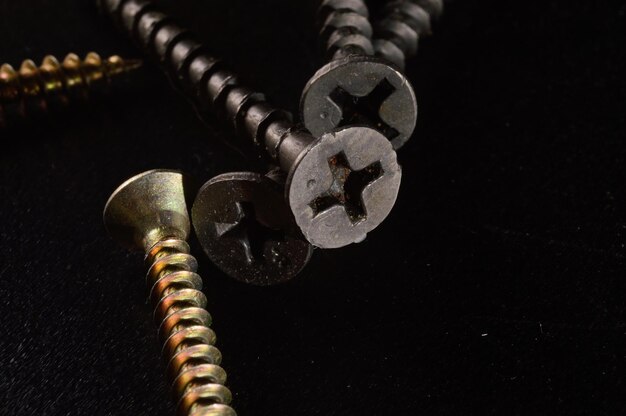 Selftapping screws on the background of a wooden board Closeup