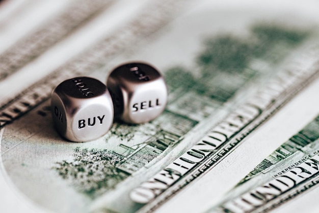 Sell and buy dice on one dollar bills Closeup stock photo