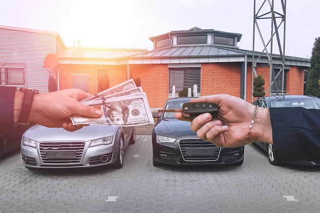 Seller of a luxury car dealership gives owner the car keys and the other pays for the dollars