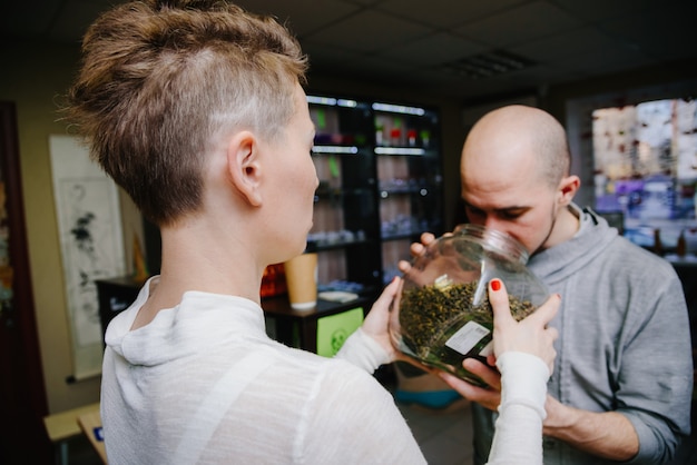 The seller offers to smell tea to the client