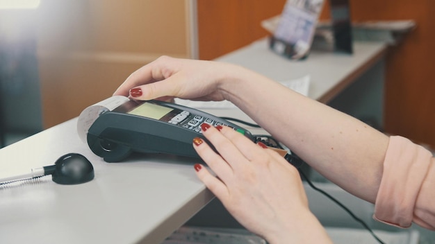 The seller in the store makes a payment by credit card, close up