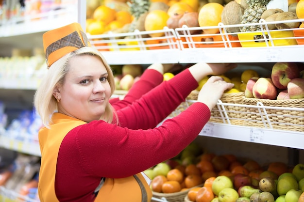 The seller in a supermarket with three hands