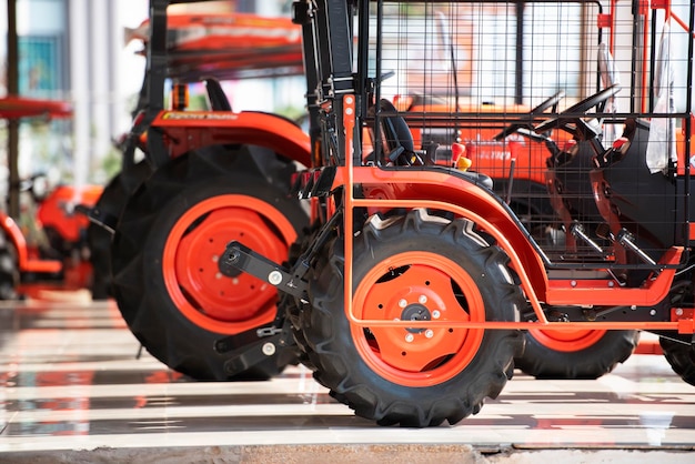 Photo selling colorful agricultural tractors in the showroom