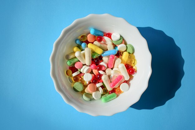 Selling pills various pills on blue background multi-colored drugs pills capsules