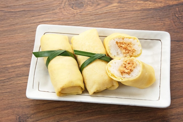 Photo semar mendem made from sticky rice with shredded chicken wrapped in an omelette or crepe