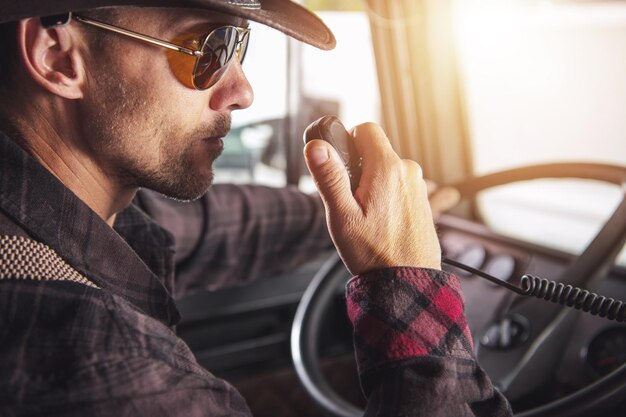 Photo semi truck driver communicating on cb radio