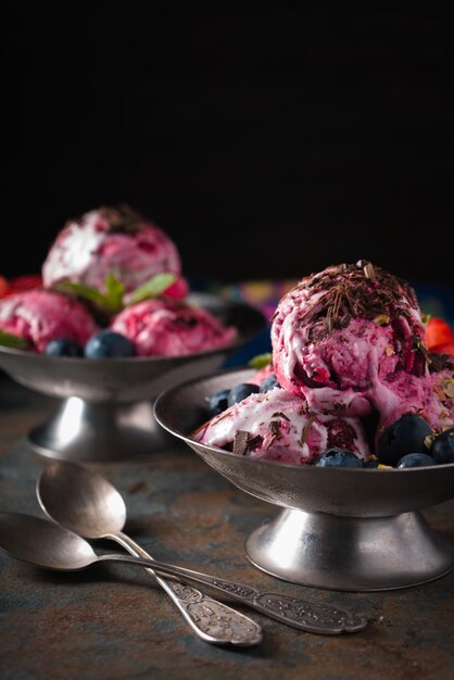 Semifreddo with berries in the metal dessert bowl on the stone vertical