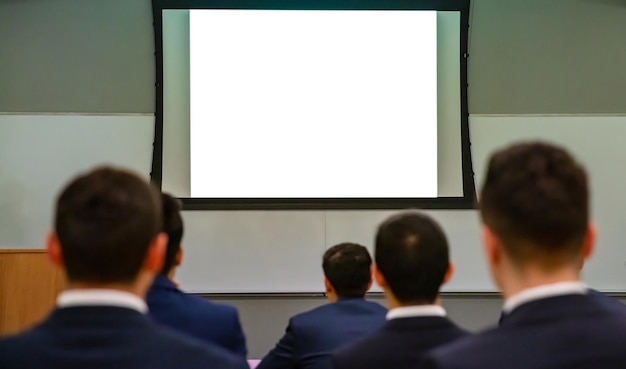 Seminar audience in class room Blank white board rear view